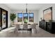 Elegant dining room with large windows, a wooden table, and modern chandelier at 13271 E Desert Vista Rd, Scottsdale, AZ 85255