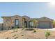 Single-story home with a two-car garage and a beautifully landscaped front yard at 13271 E Desert Vista Rd, Scottsdale, AZ 85255