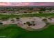 Aerial view of a golf course community at sunset at 15797 W Remington Dr, Surprise, AZ 85374