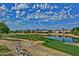 Aerial view of houses and a golf course with a lake at 15797 W Remington Dr, Surprise, AZ 85374