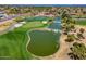 Aerial view of a golf course with water features at 15797 W Remington Dr, Surprise, AZ 85374