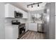 Modern kitchen featuring stainless steel appliances and white shaker cabinets at 1620 W Burgess Ln, Phoenix, AZ 85041