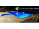 Stunning nighttime view of a refreshing pool with blue lighting at 29606 N Tarragona Dr, Peoria, AZ 85383