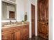 Bathroom with granite vanity, wood cabinets and tile floors at 9053 N 46Th St, Phoenix, AZ 85028