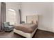 Comfortable bedroom with a tufted headboard and two armchairs at 9053 N 46Th St, Phoenix, AZ 85028