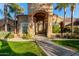 Elegant home exterior with arched entryway and landscaping at 9053 N 46Th St, Phoenix, AZ 85028