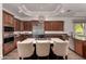 Gourmet kitchen with island, stainless steel appliances, and dark wood cabinetry at 9053 N 46Th St, Phoenix, AZ 85028