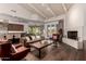 Open living room with high ceilings, fireplace, and adjacent kitchen at 9053 N 46Th St, Phoenix, AZ 85028