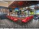 Modern bar with red chairs and circular floor tiles at 9634 E Rocky Lake Dr, Sun Lakes, AZ 85248