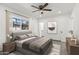 Bright bedroom featuring a ceiling fan, window with natural light, and simple, yet stylish decor at 102 W Maryland Ave # F1, Phoenix, AZ 85013