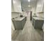 Well-lit kitchen with gray cabinets, granite countertops, and stainless steel appliances at 102 W Maryland Ave # F1, Phoenix, AZ 85013