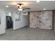 Living room featuring an open floor plan, tile floors, and statement wall with neutral marble design at 102 W Maryland Ave # F1, Phoenix, AZ 85013