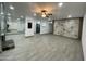 Bright living room with a ceiling fan, fireplace, and a view of the kitchen at 102 W Maryland Ave # F1, Phoenix, AZ 85013