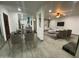 Modern living room with a decorative fireplace, sleek furniture, and open-concept design to dining area at 102 W Maryland Ave # F1, Phoenix, AZ 85013