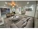 Open living room with modern decor, plush seating, and view to the backyard pool area at 102 W Maryland Ave # F1, Phoenix, AZ 85013