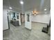 Spacious living room featuring a fireplace, ceiling fan, and views of the kitchen at 102 W Maryland Ave # F1, Phoenix, AZ 85013