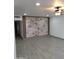 Bright living room featuring tile floors, recessed lighting, ceiling fan and a statement wall with modern accents at 102 W Maryland Ave # F1, Phoenix, AZ 85013