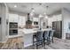 Modern kitchen with white cabinetry, quartz countertops, and stainless steel appliances at 210 E Balao Dr, Phoenix, AZ 85085