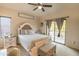 Bright bedroom with a queen-size bed and access to a private balcony at 21655 N 36Th Ave # 117, Glendale, AZ 85308