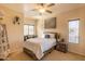 Bright bedroom with a double bed, window, and ceiling fan at 21655 N 36Th Ave # 117, Glendale, AZ 85308