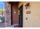 Inviting entryway with a black wrought iron door and a stone accent wall at 21655 N 36Th Ave # 117, Glendale, AZ 85308