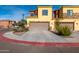 Two-car garage with tan garage door and a curved driveway at 21655 N 36Th Ave # 117, Glendale, AZ 85308