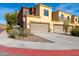 Two-car garage with tan garage door and a curved driveway at 21655 N 36Th Ave # 117, Glendale, AZ 85308