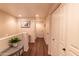 Upstairs hallway with hardwood floors and white doors at 21655 N 36Th Ave # 117, Glendale, AZ 85308