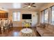 Living room with comfortable couch and large TV at 21655 N 36Th Ave # 117, Glendale, AZ 85308