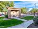 Relaxing pool area with a covered patio and picnic tables at 21655 N 36Th Ave # 117, Glendale, AZ 85308