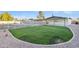 Green backyard with a grass area and rock landscaping, along with a fenced pool at 2364 W Emelita Ave, Mesa, AZ 85202