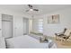 Light-filled bedroom featuring a comfy accent chair and a ceiling fan at 2364 W Emelita Ave, Mesa, AZ 85202