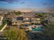 Expansive backyard with a pool, spa, lush landscaping, and a covered patio overlooking the scenic neighborhood at 3428 N Park St, Buckeye, AZ 85396