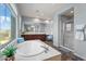Spa-like bathroom with soaking tub, double vanity and shower at 3428 N Park St, Buckeye, AZ 85396