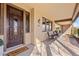 Inviting front porch with a double wooden door and wicker chairs at 3428 N Park St, Buckeye, AZ 85396