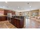 Open kitchen with island, stainless steel appliances, and breakfast nook at 3428 N Park St, Buckeye, AZ 85396