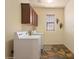 Bright laundry room with washer, dryer, and ample storage at 3428 N Park St, Buckeye, AZ 85396