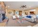 Open living room with a stone fireplace and views to kitchen at 3428 N Park St, Buckeye, AZ 85396