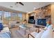 Living room with a stone fireplace and comfortable seating at 3428 N Park St, Buckeye, AZ 85396