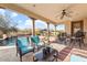 Covered patio with comfortable seating, a table, and views of the pool at 3428 N Park St, Buckeye, AZ 85396