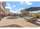 Spacious pool and spa with comfortable lounge chairs and patio umbrella at 3428 N Park St, Buckeye, AZ 85396