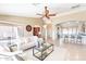 Open-concept living room with a ceiling fan, neutral color scheme, and an archway leading to another room at 3735 N 162Nd Ln, Goodyear, AZ 85395