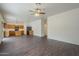 Open living room with dark wood floors and kitchen view at 9202 W Cambridge Ave, Phoenix, AZ 85037