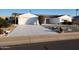 White single-story home with a two-car garage and desert landscaping at 10018 W Burns Dr, Sun City, AZ 85351