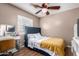 Cozy bedroom with a full-size bed and a ceiling fan at 12425 W Willow Ave, El Mirage, AZ 85335