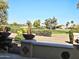 Backyard view of a golf course with lush greenery and houses in the background at 13414 W Micheltorena Dr, Sun City West, AZ 85375