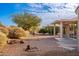 Landscaped backyard with covered patio and desert plants at 14426 W Gunsight Dr, Sun City West, AZ 85375