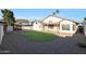 Backyard with covered patio and a kidney shaped lawn at 19822 N 43Rd Dr, Glendale, AZ 85308