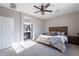 Spacious bedroom with en-suite bathroom and ceiling fan at 22651 E Creosote Dr, Queen Creek, AZ 85142