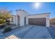 Front view of a house with a two-car garage and driveway at 22651 E Creosote Dr, Queen Creek, AZ 85142